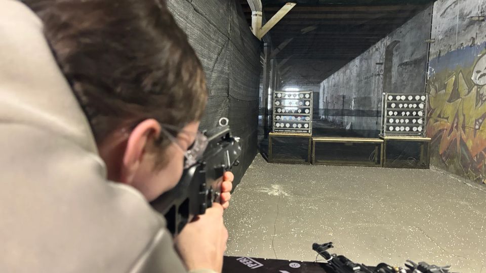 man aiming an airsoft replica at a target