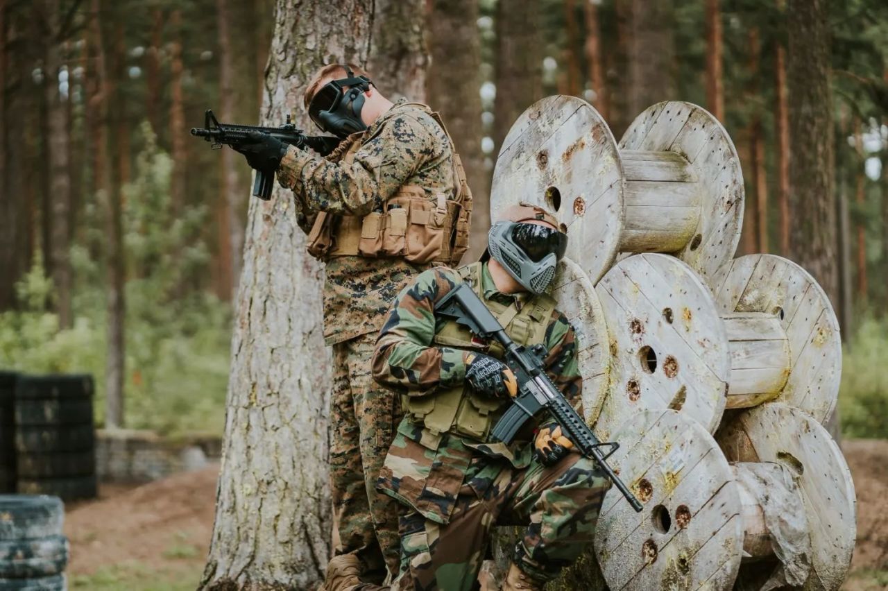 Airsoft player with a replica and full face protection