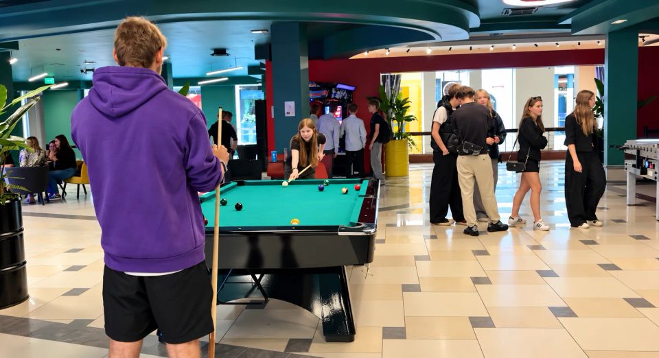 colleagues playing billiards at a team building event