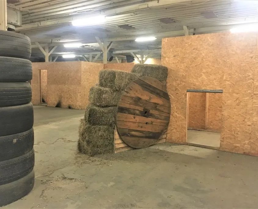 Juglas iekštelpu lāzertaga laukums ar riepu un siena ķīpu aizsegiem