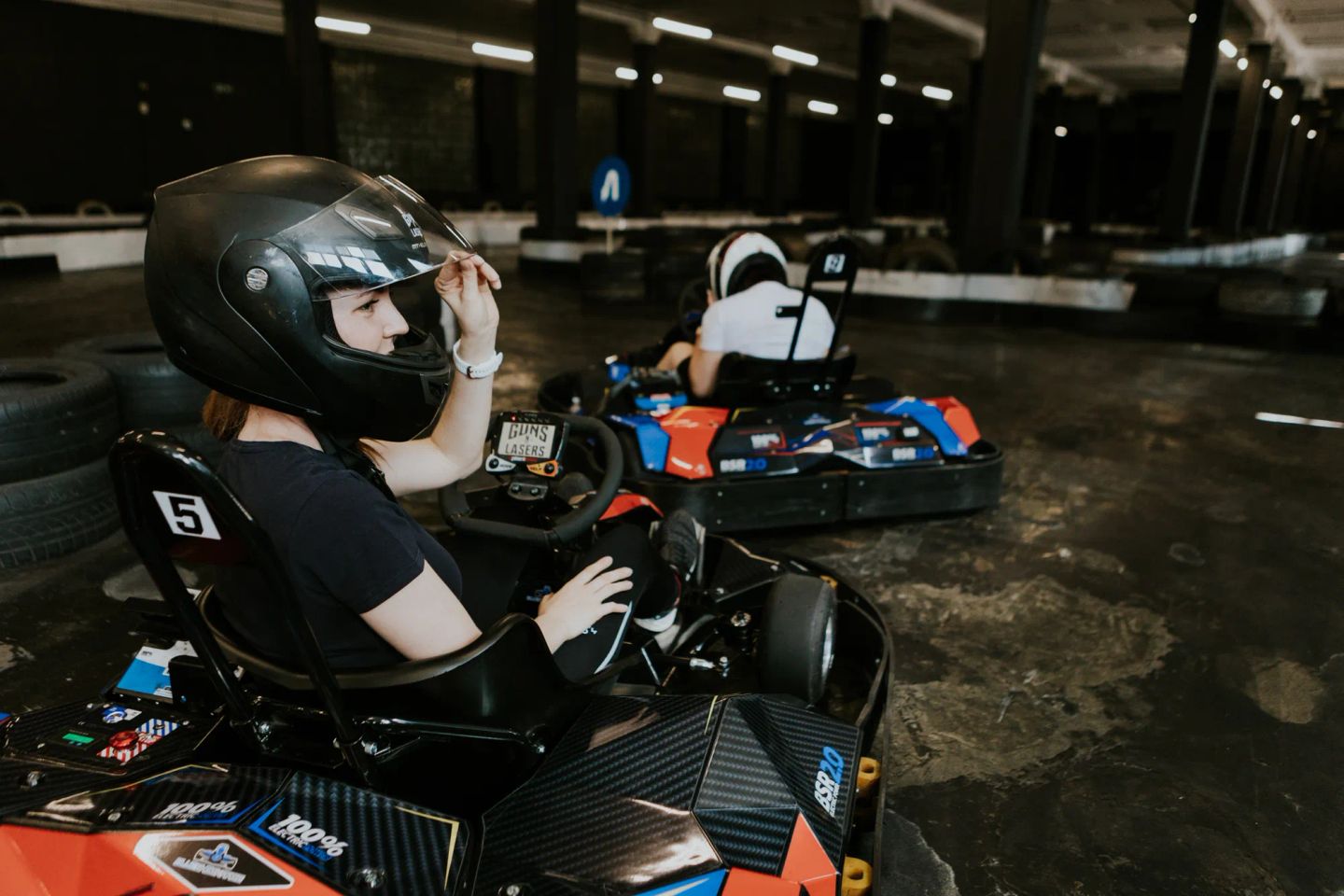 Two electric go-karts. The drivers are getting ready for the first lap.