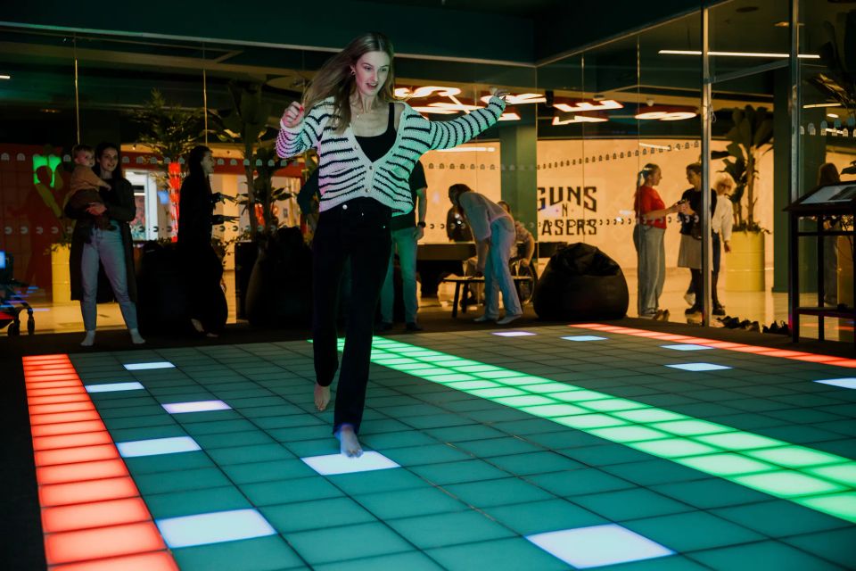 Woman jumping across the LED tiles in the Pixel Room
