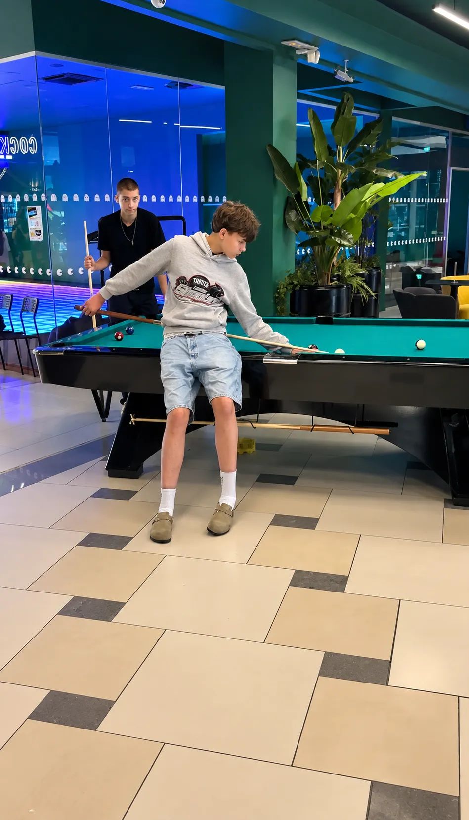 friends relaxing while playing billiards